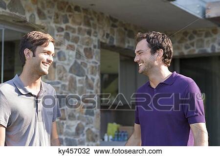 Two male friends smiling View Large Photo Image Stock Image - Two male friends smiling. Fotosearch