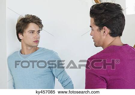 Two male friends talking to each other View Large Photo Image Stock Photography - Two male friends talking to each other. Fotosearch