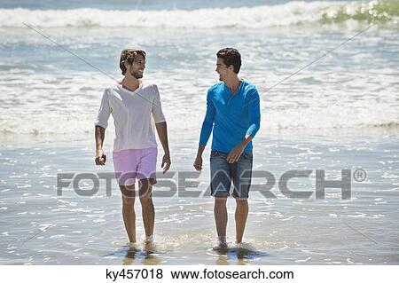Two men enjoying on the beach View Large Photo Image Stock Photo - Two men enjoying on the beach. Fotosearch
