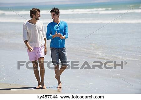 Two men walking on the beach View Large Photo Image Picture - Two men walking on the beach. Fotosearch