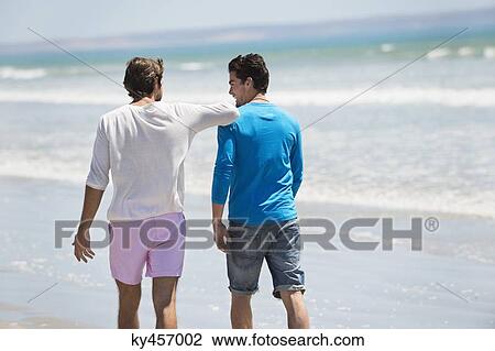 Two men walking on the beach View Large Photo Image Stock Image - Two men walking on the beach. Fotosearch