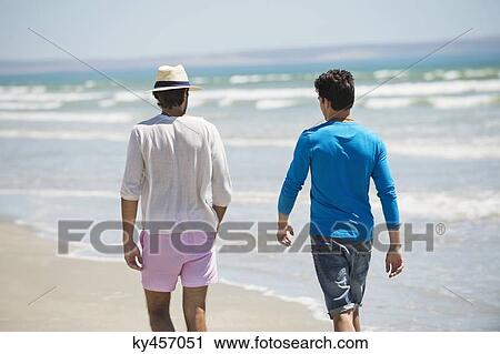 Two men walking on the beach View Large Photo Image Stock Image - Two men walking on the beach. Fotosearch