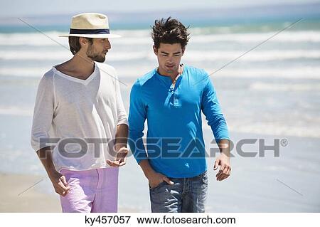 Two men walking on the beach View Large Photo Image Stock Photo - Two men walking on the beach. Fotosearch