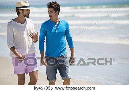 Two men walking on the beach View Large Photo Image Stock Photography - Two men walking on the beach. Fotosearch