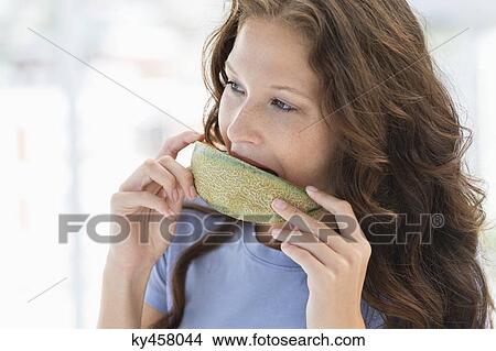 Close-up of a woman eating melon View Large Photo Image Picture - Close-up of a woman eating melon. Fotosearch