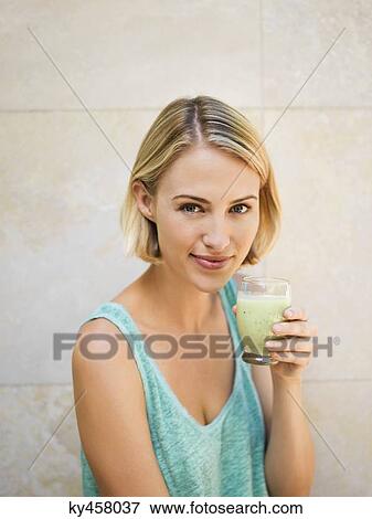 Stock Photo - Woman drinking juice. Fotosearch