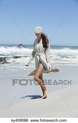 Beautiful woman walking on the beach in winter View Large Photo Image Stock Photo - Beautiful woman walking on the beach in winter. Fotosearch