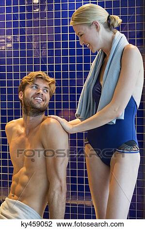 Couple smiling in a locker room View Large Photo Image Stock Image - Couple smiling in a locker room. Fotosearch
