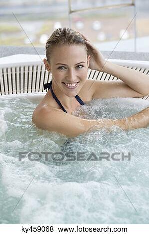 Portrait of a smiling beautiful woman in a hot tub View Large Photo Image Stock Photo - Portrait of a smiling beautiful woman in a hot tub. Fotosearch