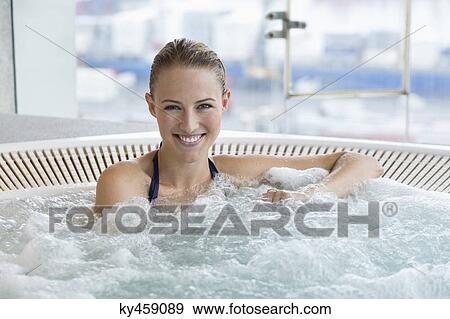 Portrait of a smiling beautiful woman in a hot tub View Large Photo Image Stock Photo - Portrait of a smiling beautiful woman in a hot tub. Fotosearch