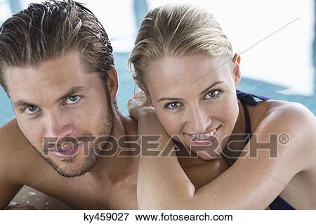 Portrait of a smiling couple at the poolside View Large Photo Image Stock Photo - Portrait of a smiling couple at the poolside. Fotosearch