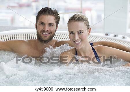 Stock Photograph - Portrait of a smiling couple in a hot tub. Fotosearch