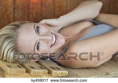 Portrait of a smiling woman relaxing in a sauna View Large Photo Image Stock Photo - Portrait of a smiling woman relaxing in a sauna. Fotosearch