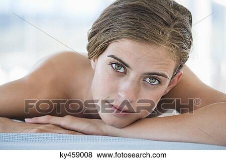 Stock Photo - Portrait of a woman lying on a massage table. Fotosearch