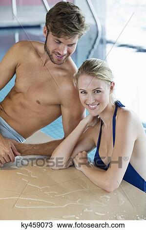 Smiling couple at the poolside View Large Photo Image Stock Image - Smiling couple at the poolside. Fotosearch