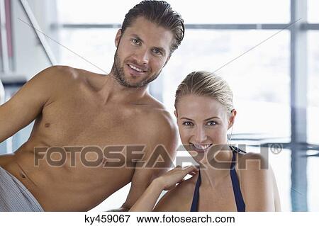 Stock Photo - Smiling couple at the poolside. Fotosearch