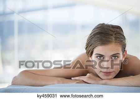 Woman lying on a massage table View Large Photo Image Stock Image - Woman lying on a massage table. Fotosearch
