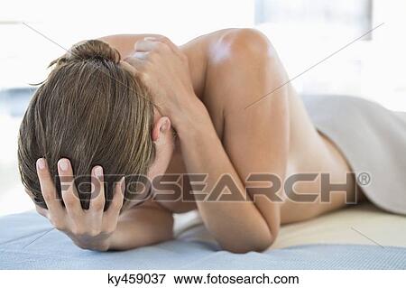 Stock Photo - Woman lying on a massage table. Fotosearch