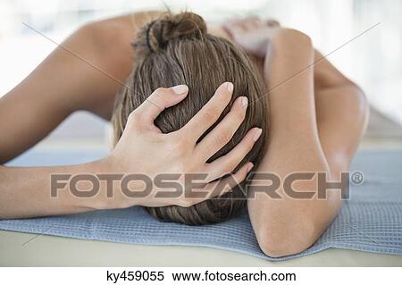 Woman lying on a massage table View Large Photo Image Stock Photography - Woman lying on a massage table. Fotosearch