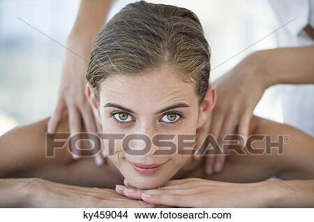 Woman receiving back massage from a massage therapist View Large Photo Image Picture - Woman receiving back massage from a massage therapist. Fotosearch