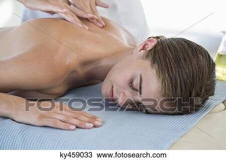Woman receiving back massage from a massage therapist View Large Photo Image Stock Image - Woman receiving back massage from a massage therapist. Fotosearch