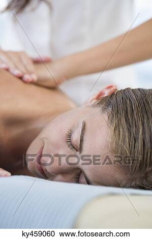 Woman receiving back massage from a massage therapist View Large Photo Image Stock Image - Woman receiving back massage from a massage therapist. Fotosearch