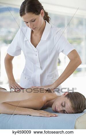 Stock Photo - Woman receiving back massage from a massage therapist. Fotosearch