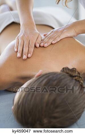 Woman receiving back massage from a massage therapist View Large Photo Image Stock Photo - Woman receiving back massage from a massage therapist. Fotosearch