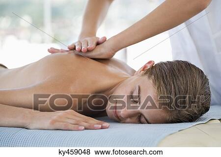 Woman receiving back massage from a massage therapist View Large Photo Image Stock Photo - Woman receiving back massage from a massage therapist. Fotosearch