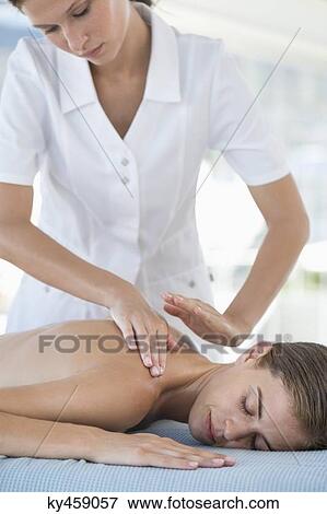 Stock Photo - Woman receiving back massage from a massage therapist. Fotosearch
