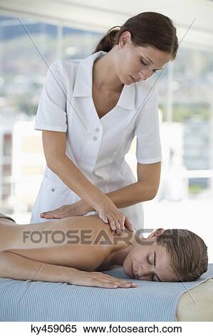 Woman receiving back massage from a massage therapist View Large Photo Image Stock Photography - Woman receiving back massage from a massage therapist. Fotosearch