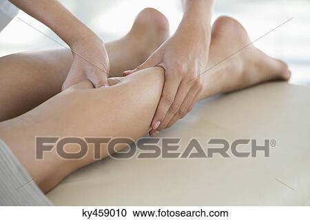 Woman receiving leg massage from a massage therapist View Large Photo Image Stock Image - Woman receiving leg massage from a massage therapist. Fotosearch