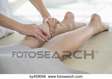 Woman receiving leg massage from a massage therapist View Large Photo Image Stock Photograph - Woman receiving leg massage from a massage therapist. Fotosearch