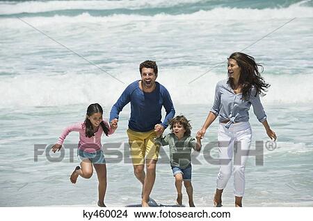 Family enjoying on the beach View Large Photo Image Picture - Family enjoying on the beach. Fotosearch