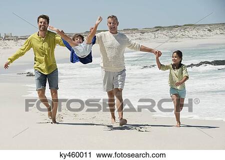 Family enjoying on the beach View Large Photo Image Stock Image - Family enjoying on the beach. Fotosearch