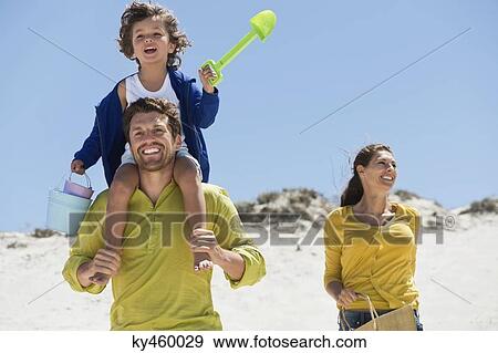 Family enjoying on the beach View Large Photo Image Stock Photo - Family enjoying on the beach. Fotosearch