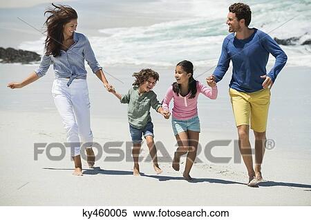 Stock Photography - Family enjoying on the beach. Fotosearch