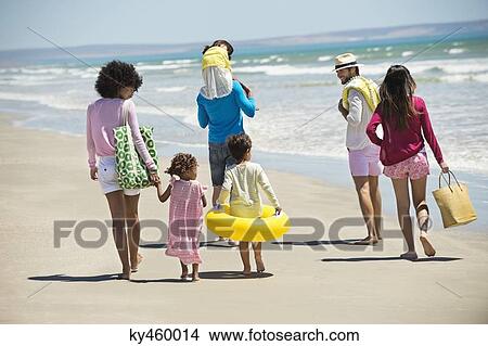 Family enjoying vacations on the beach View Large Photo Image Picture - Family enjoying vacations on the beach. Fotosearch