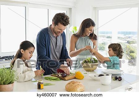 Stock Photo - Family preparing food. Fotosearch