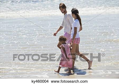 Family walking on the beach View Large Photo Image Picture - Family walking on the beach. Fotosearch