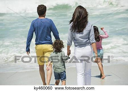 Family walking on the beach View Large Photo Image Stock Image - Family walking on the beach. Fotosearch