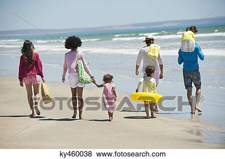 Family walking on the beach View Large Photo Image Stock Photo - Family walking on the beach. Fotosearch