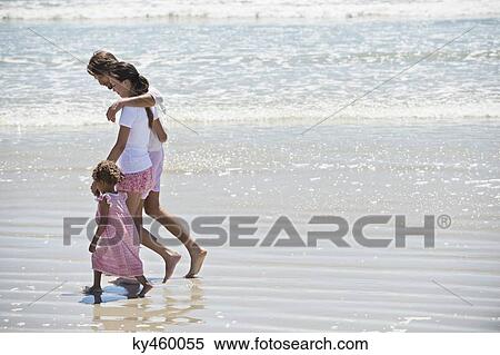 Family walking on the beach View Large Photo Image Stock Photography - Family walking on the beach. Fotosearch