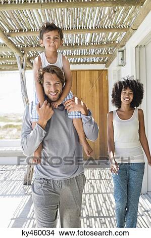 Man carrying his son on shoulders View Large Photo Image Picture - Man carrying his son on shoulders. Fotosearch