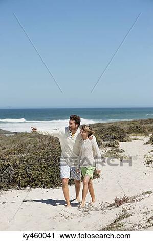Man pointing with his son on the beach View Large Photo Image Stock Image - Man pointing with his son on the beach. Fotosearch