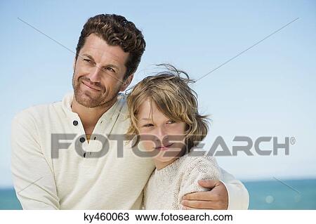 Man with his son on the beach View Large Photo Image Stock Image - Man with his son on the beach. Fotosearch