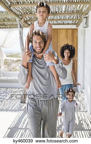 Stock Photo - Smiling parents with their children. Fotosearch