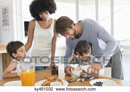 Family having breakfast at a dining table View Large Photo Image Stock Image - Family having breakfast at a dining table. Fotosearch