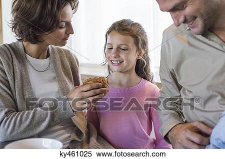 Family having breakfast at a kitchen counter View Large Photo Image Stock Photography - Family having breakfast at a kitchen counter. Fotosearch