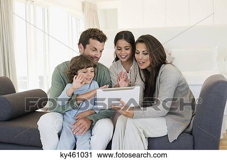Stock Image - Family looking at a digital tablet. Fotosearch